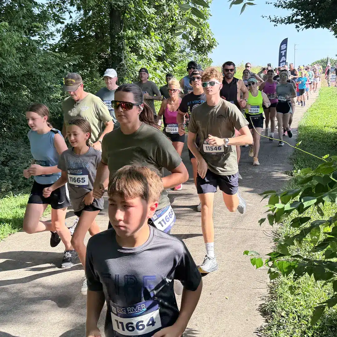 Group Running Starting Line 5K 1080 Runners of all ages make their way along the course during the inaugural Run to Remember 5K & Walk of Remembrance at Missouri's National Veterans Memorial.